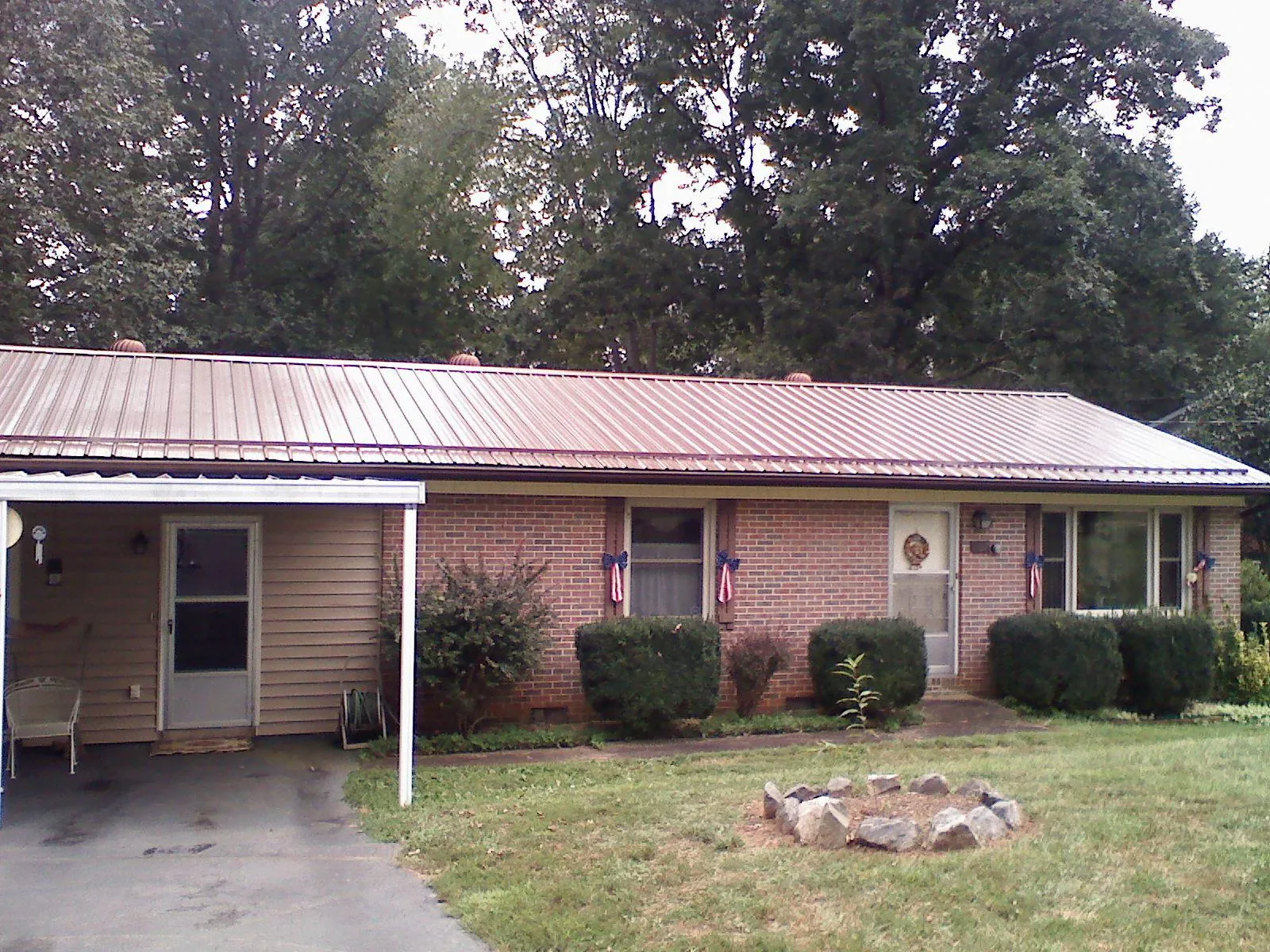 Bronze metal roof and carport on a brick ranch home — Roof Repair work by our crew in Little Switzerland